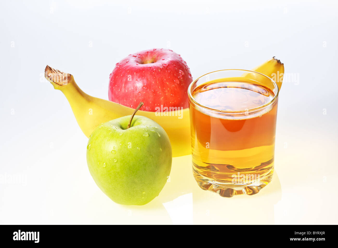 Banana, green and red apples and glass of apple juice Stock Photo Alamy