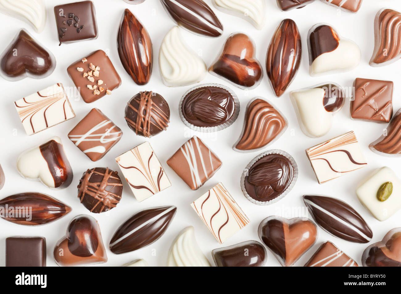 Various sorts of luxury confectionary chocolate on white Stock Photo