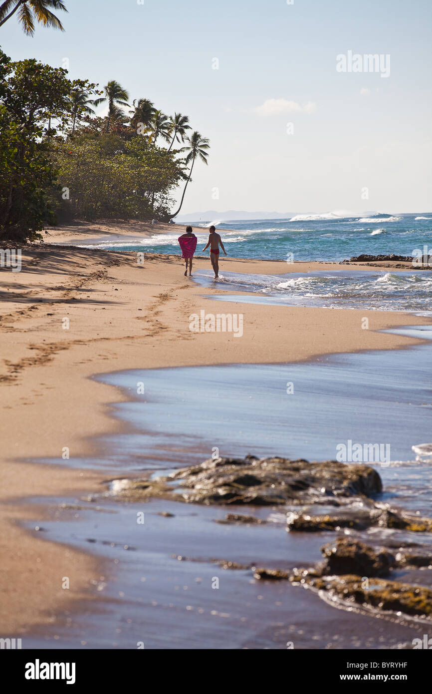 A couple walk down Steps beach in Rincon Puerto Rico Stock Photo