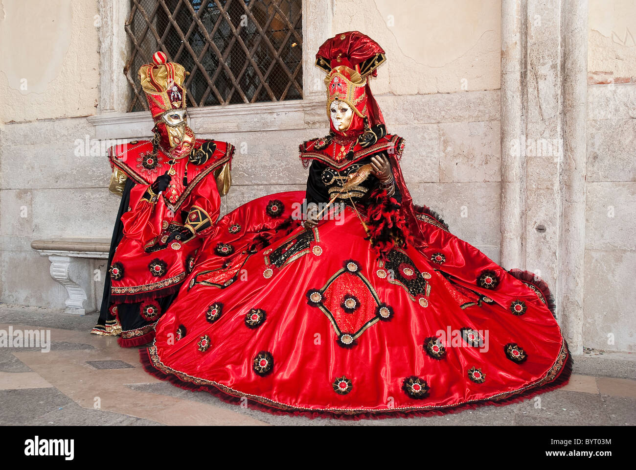 A couple of venetian masks during Carnival with red and gold disguise ...