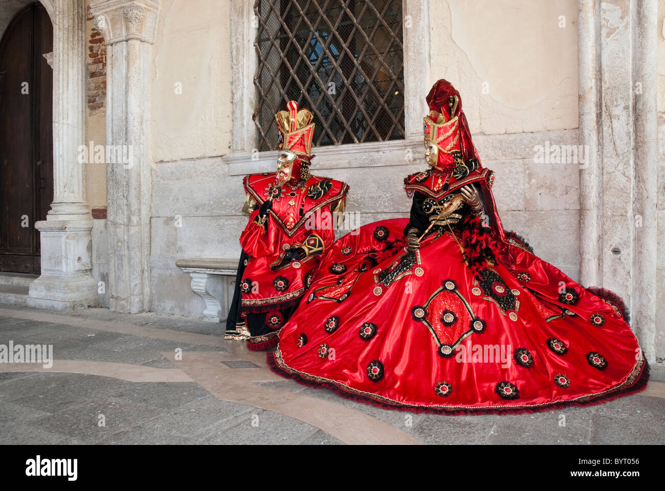 A couple of venetian masks during Carnival with red and gold disguise ...