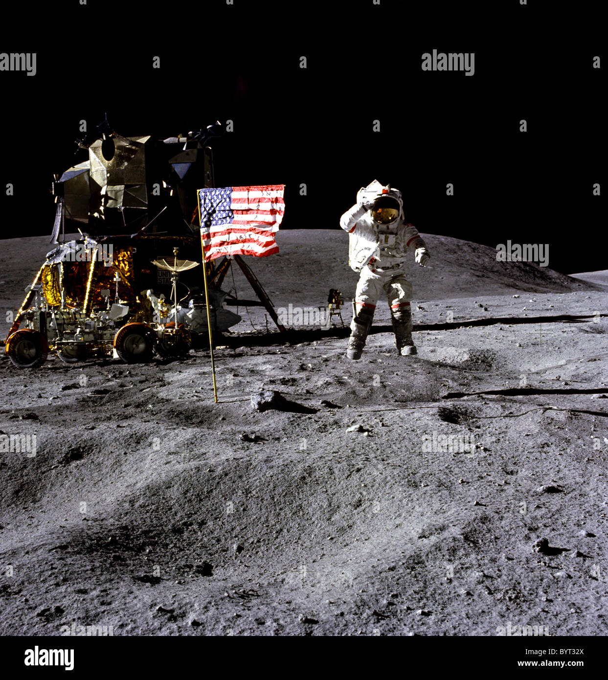 Astronaut John W. Young jumps and salutes the U.S. flag during the Apollo 16 lunar landing mission. Stock Photo