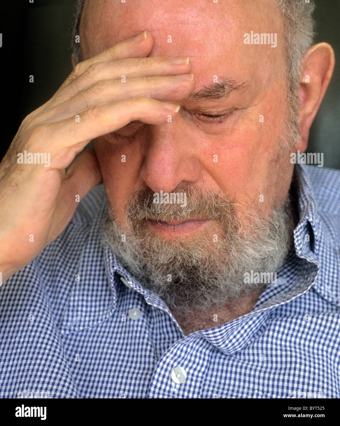 Elderly care at home. Closeup of adult man with hand to his head Stock Photo