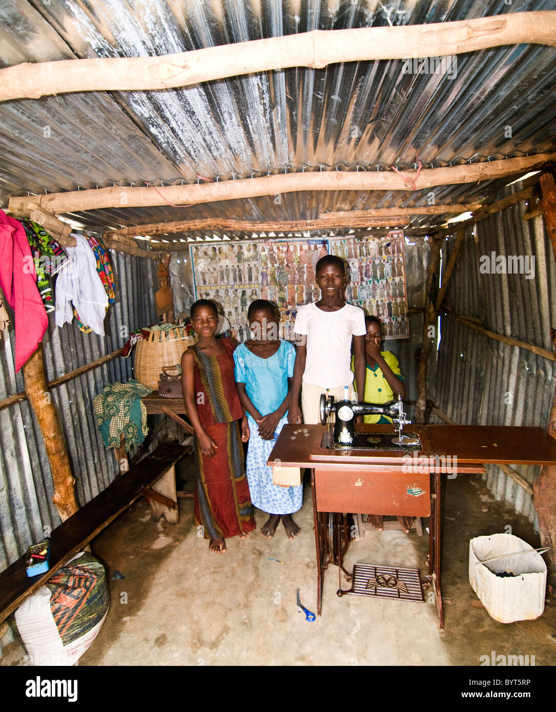 Female tailors in a tiny tailor shop in north Benin. Stock Photo