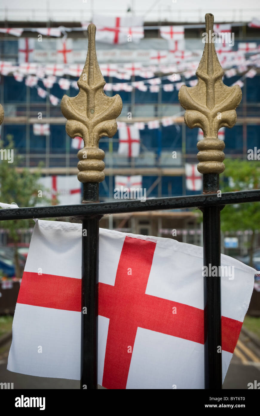 St George's Cross flag draped over a wrought iron gate to celebrate the 2010 World Cup. Stock Photo