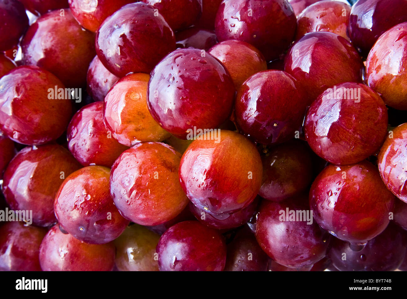 Background of red grapes with water droplets Stock Photo
