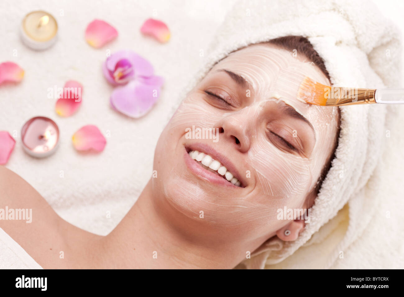 Applying of soothing mask, young woman getting spa procedures. Stock Photo