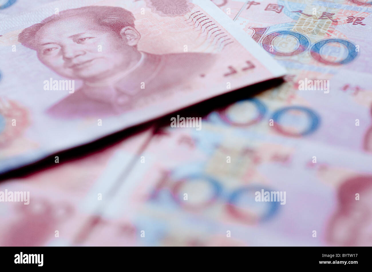 brand new 100 RMB Chinese bank notes showing the image of the late chairman Mao, arranged side by side and on top of each other Stock Photo