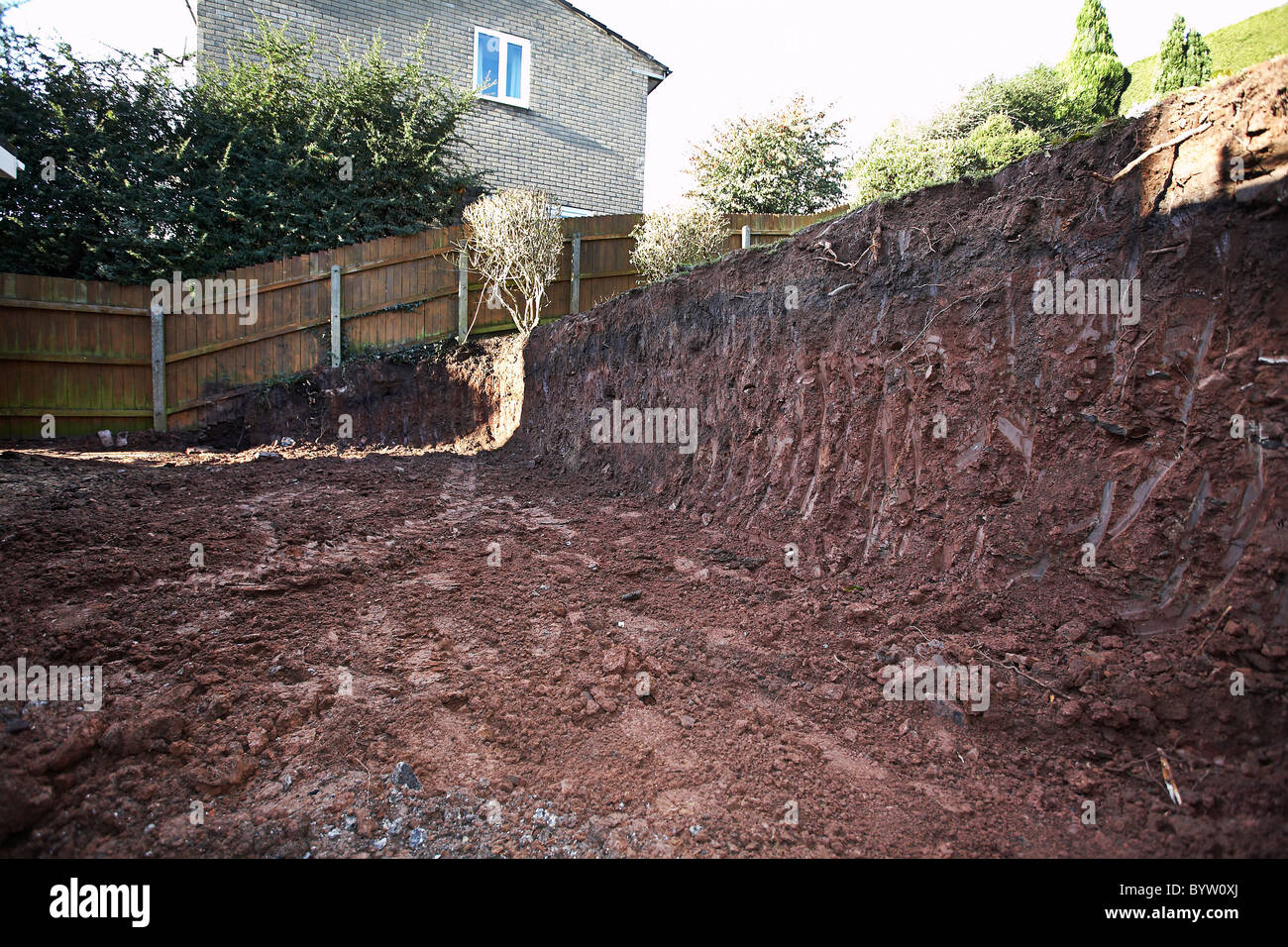 Excavating earth and preparing for an extension and patio at the back of a house Stock Photo Alamy