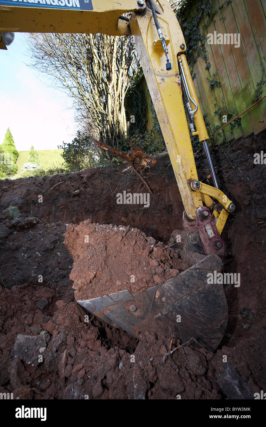 Excavating earth and preparing for an extension and patio at the back of a house Stock Photo Alamy