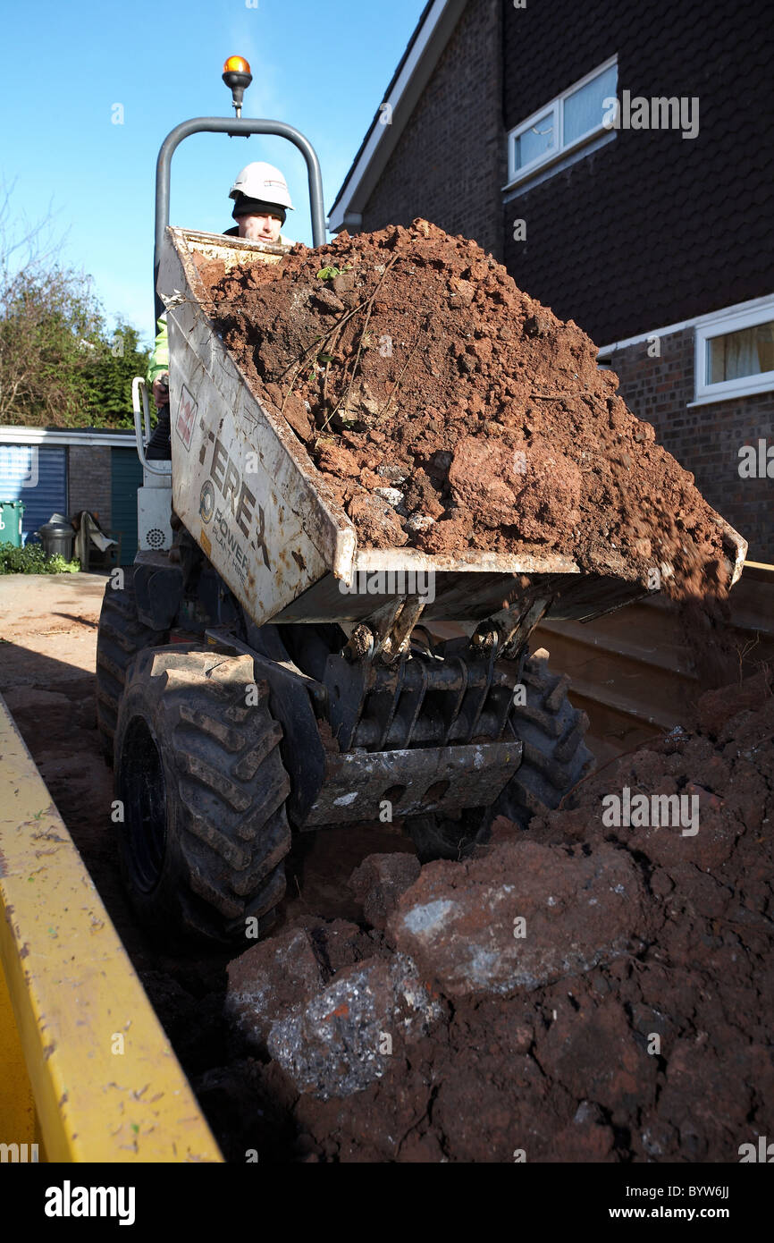 Dump truck emptying its bucket full of earth into a skip Stock Photo Alamy