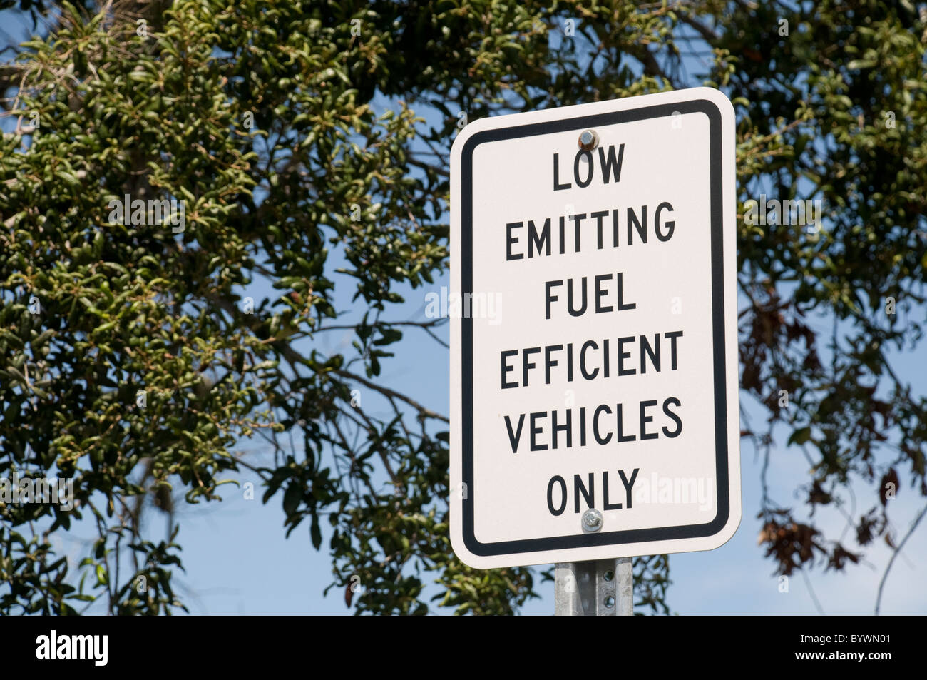 Low Emitting Fuel Efficient Vehicles Only Sign in Parking Lot Stock Photo