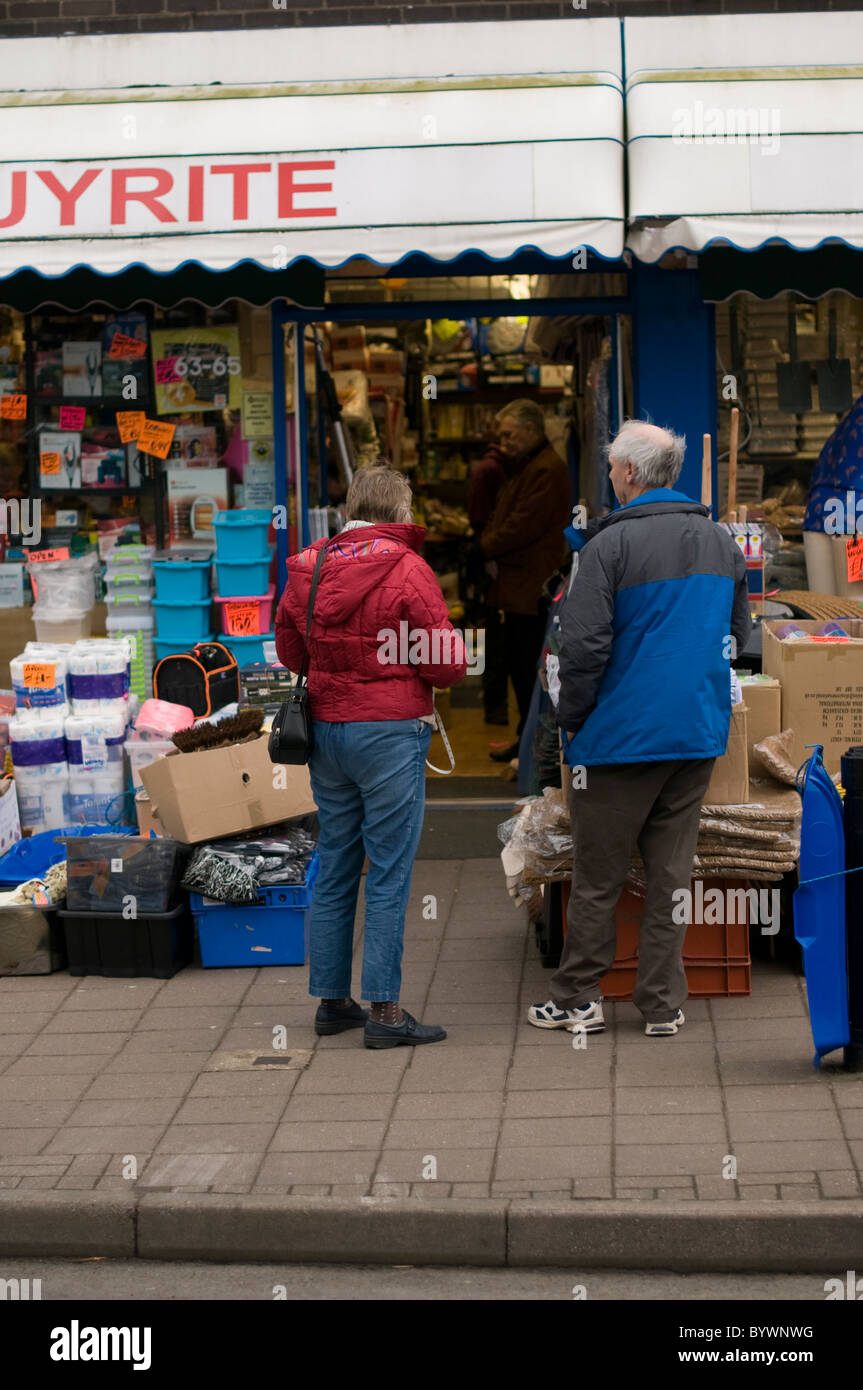Elderly couple shopping for a bargain in a small independent shop in Kenilworth, Warwickshire. Stock Photo