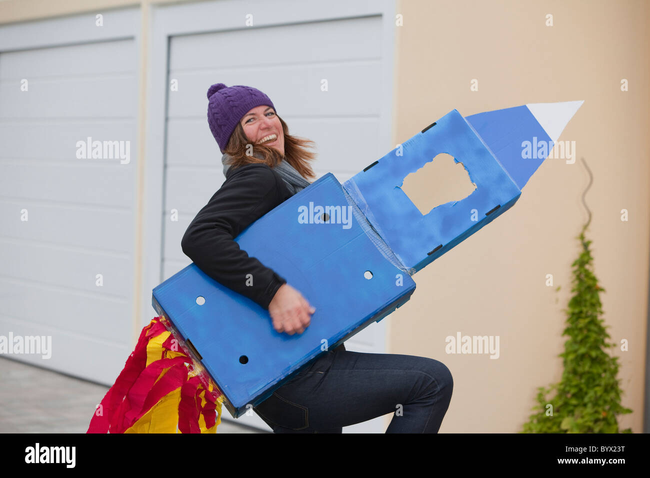 Woman with selfmade rocket, smiling Stock Photo - Alamy