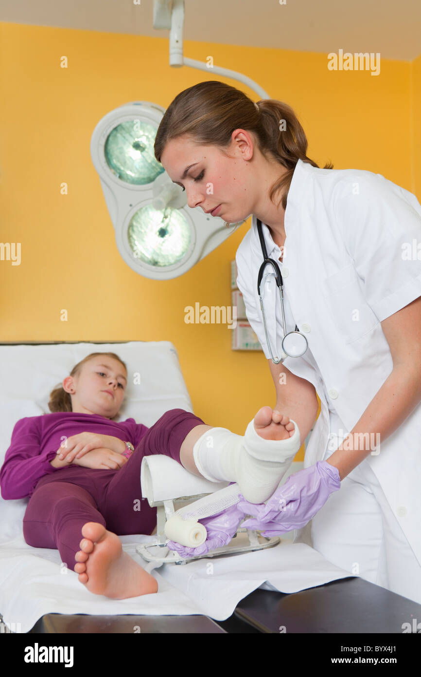Nurse applying a dressing at girls foot Stock Photo Alamy