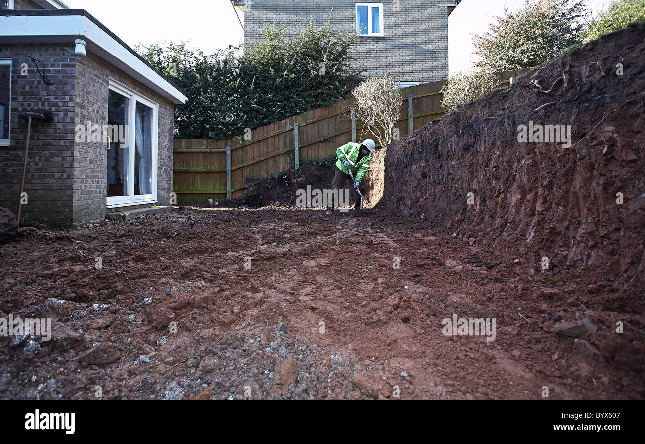 Excavating earth and preparing for an extension and patio at the back of a house Stock Photo Alamy
