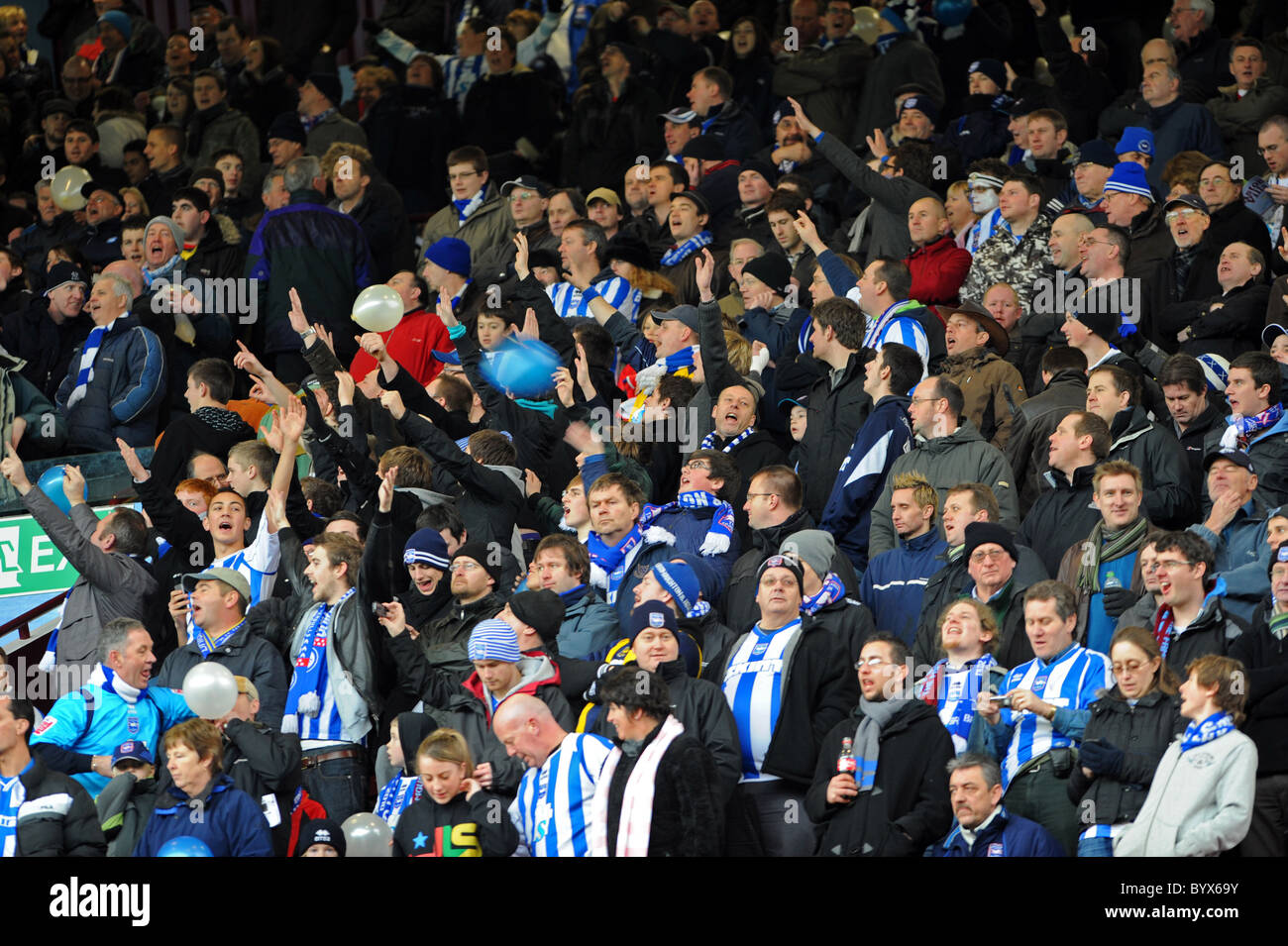 Brighton football fans cheering on their team at Aston Villa Stock Photo