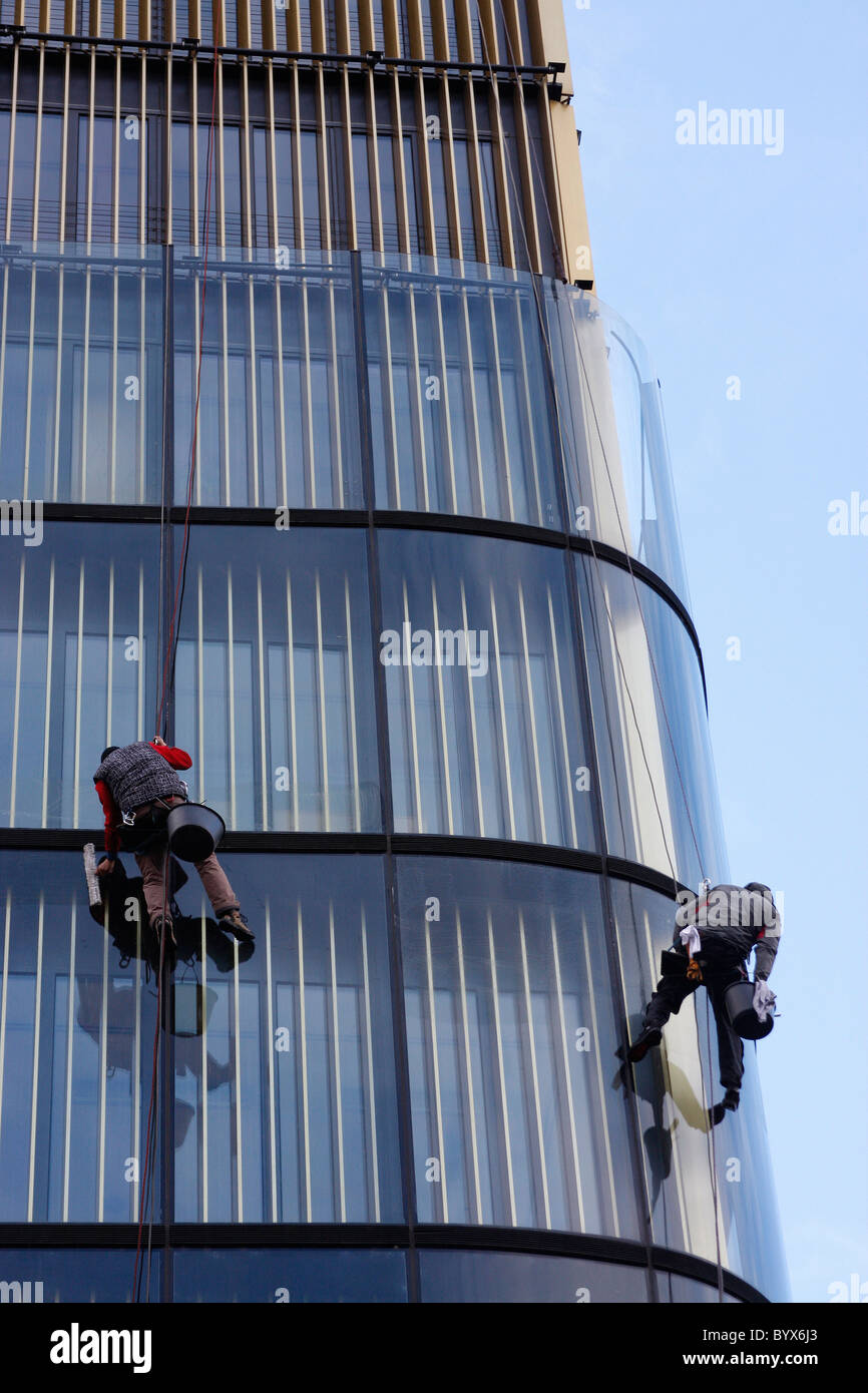 High rise window cleaners at work on a building in Prague city,Czech Republic Stock Photo