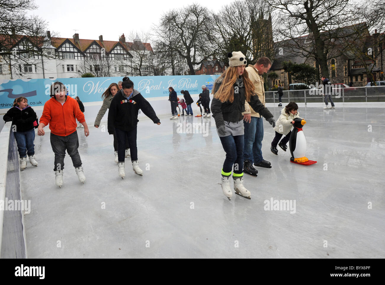 Skaters enjoying the temporary ice rink in Worthing's Steyne Gardens Stock Photo