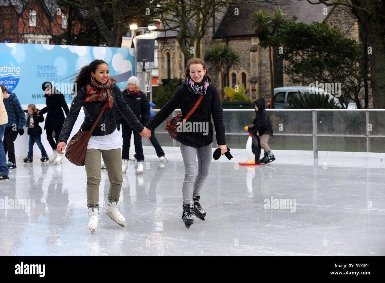 Skaters enjoying the temporary ice rink in Worthing's Steyne Gardens Stock Photo