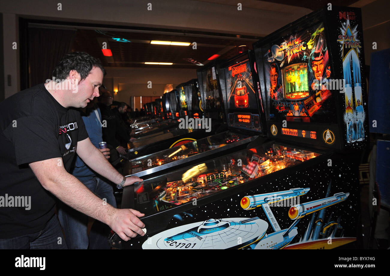 Playing Pinball during South Coast Slam 2011 an event in Worthing for people to play Pinball and video games Stock Photo