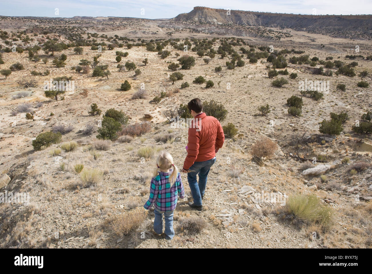 Mother and child take a walk in the high desert of Cuba, New Mexico, looking for fossils. Stock Photo