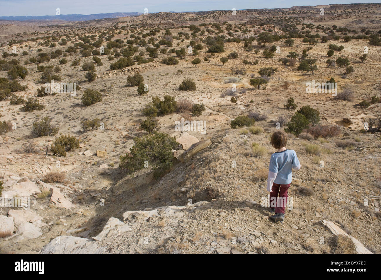 Eight year old boy going off on his own, hiking the high desert of New Mexico, USA Stock Photo