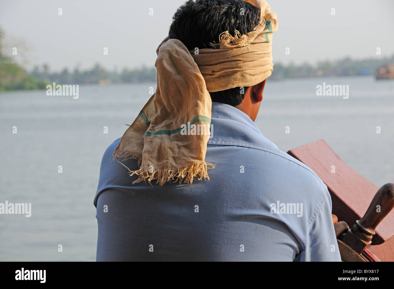 Houseboat on the Backwaters of Kerala being driven by the boat captain, India Stock Photo