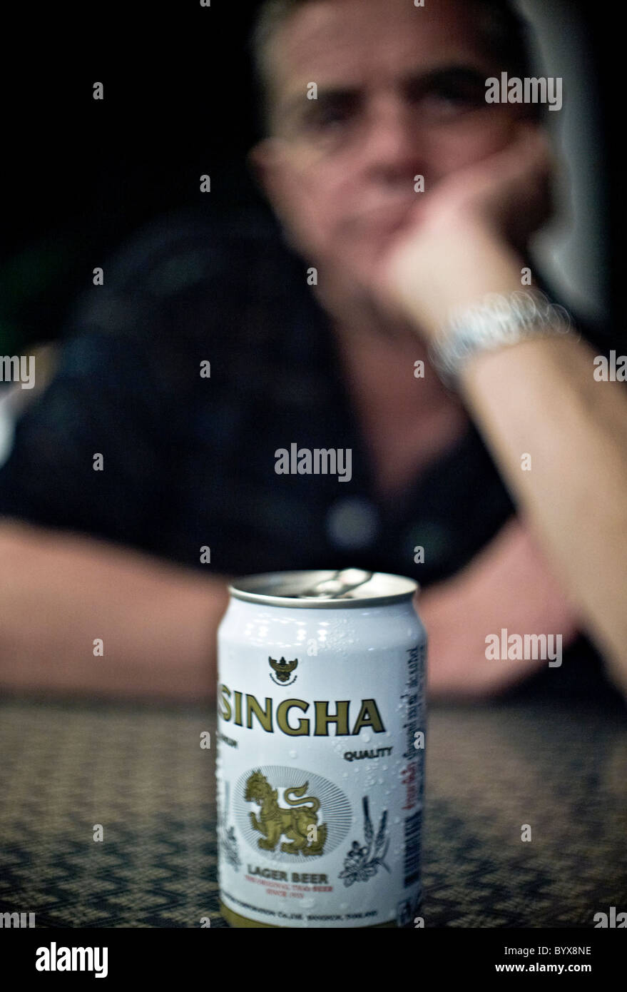 Contemplative man and an empty beer can. Thailand S. E. Asia Stock Photo