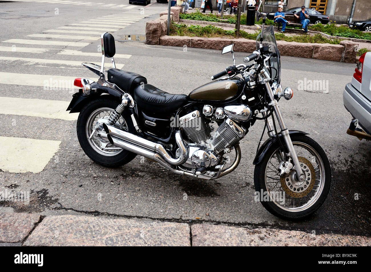 A Yamaha XV535 Virago with highly polished chromium plated exhaust pipes parked in an Helsinki Road, Finland Stock Photo
