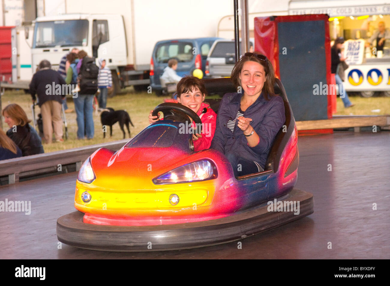 Mom and daughter enjoying the bumping cars at The Black Isle showground, Muir of Ord. Stock Photo