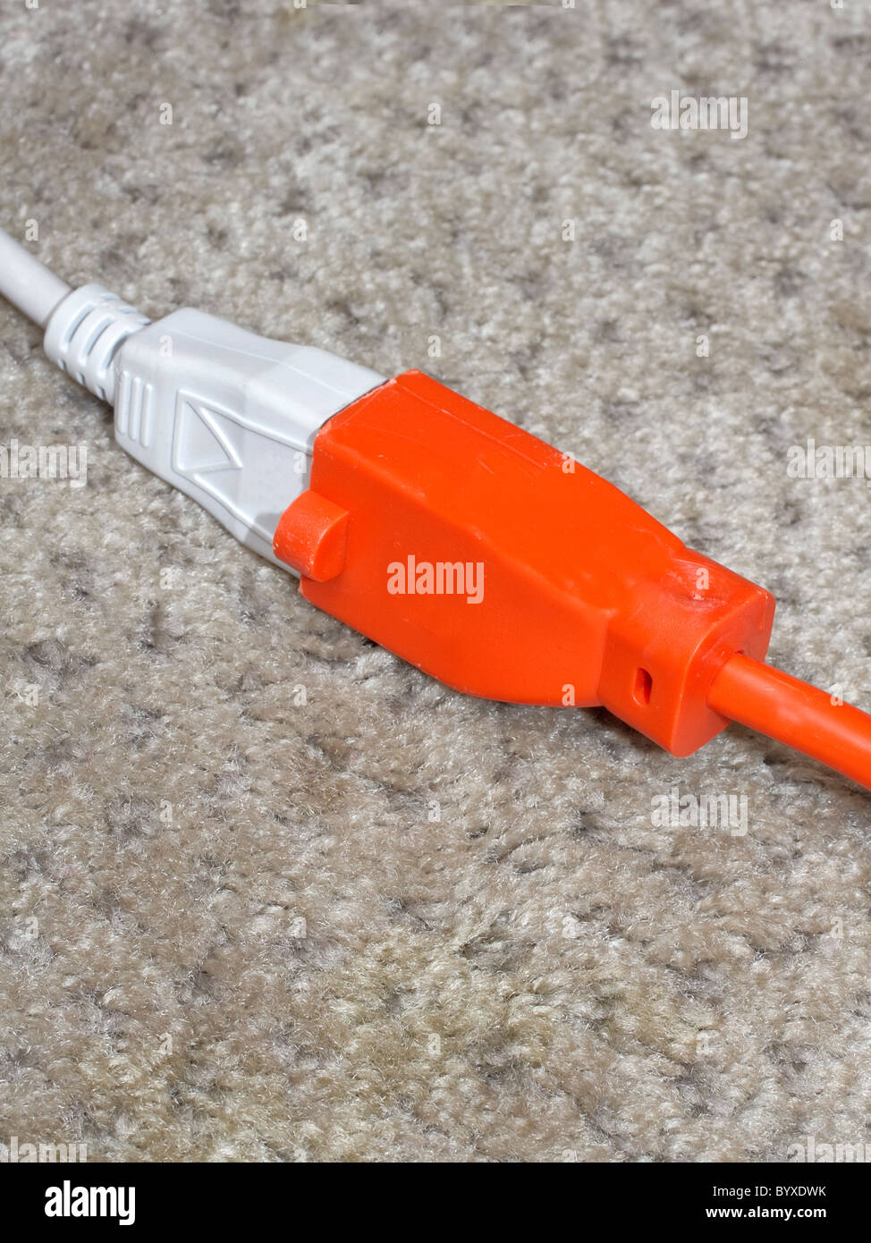 An electrical cord plugged into an extension cord Stock Photo Alamy