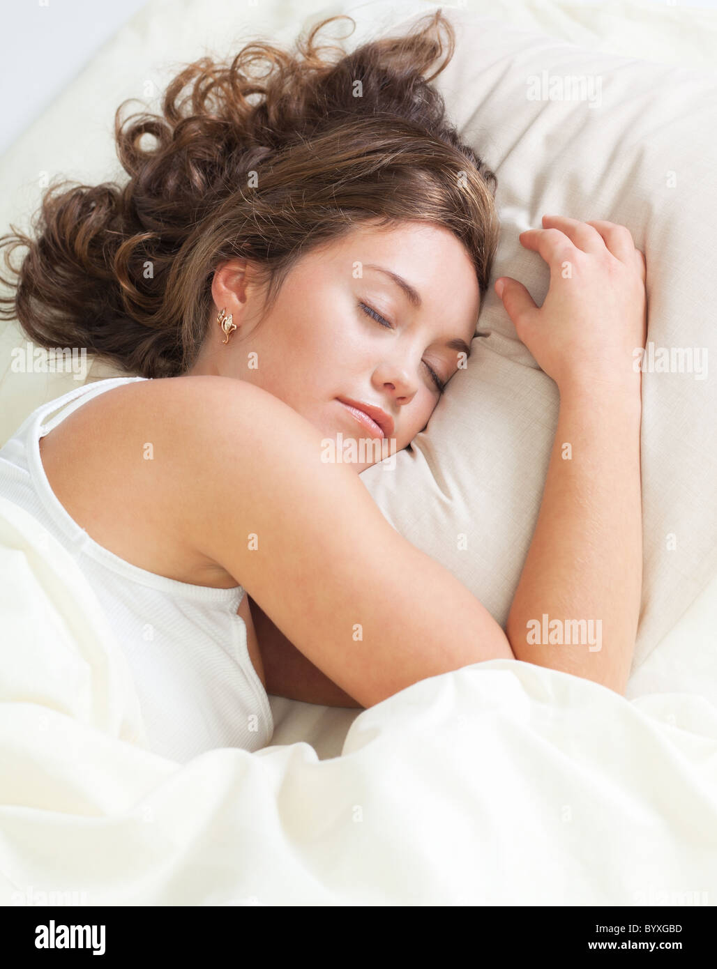 Pretty young woman sleeps in her bed Stock Photo