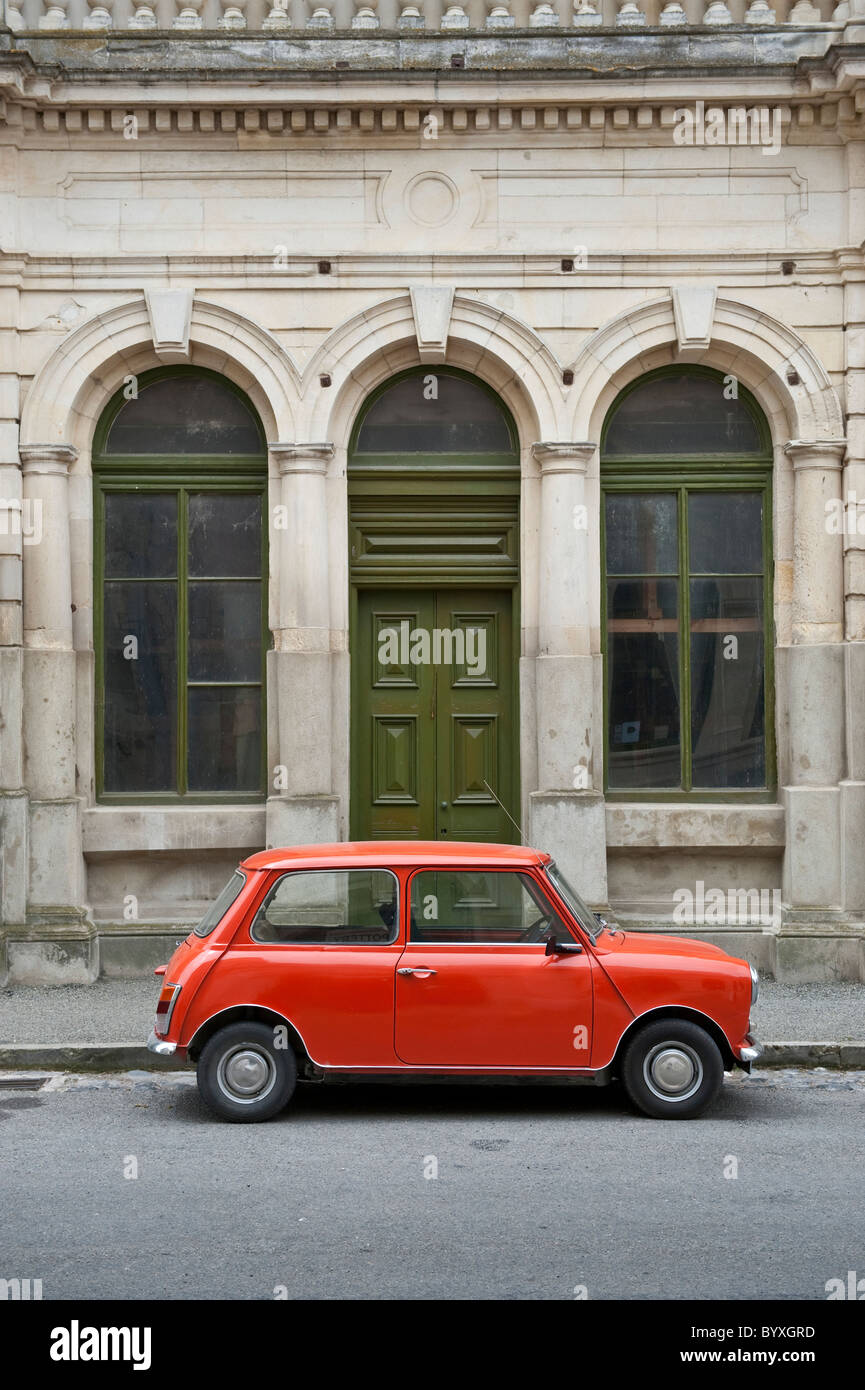 A bright orange mark 3 Mini parked in Harbour Street, Oamaru, on New Zealand's South Island Stock Photo