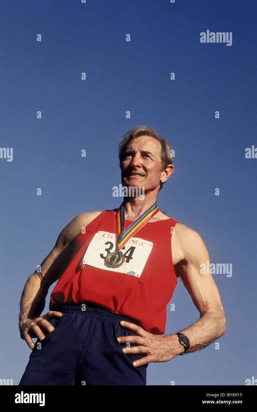 Elderly male track and field athlete with his gold medal Stock Photo
