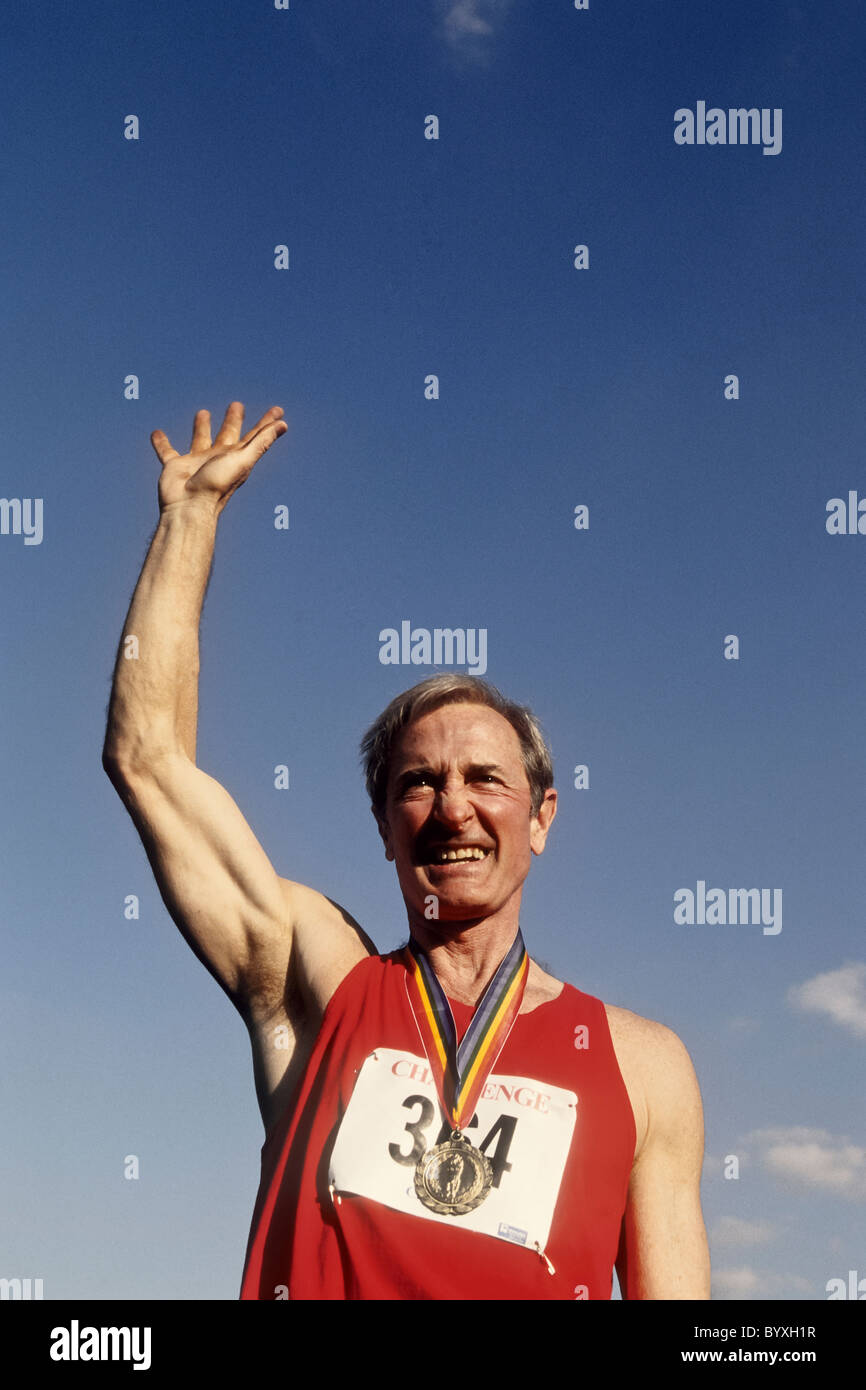 Elderly male track and field athlete with his gold medal Stock Photo