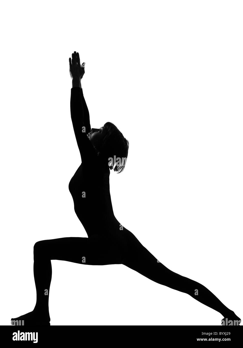 woman virabhadrasana warrior postion yoga pose posture position in silouhette on studio white background Stock Photo