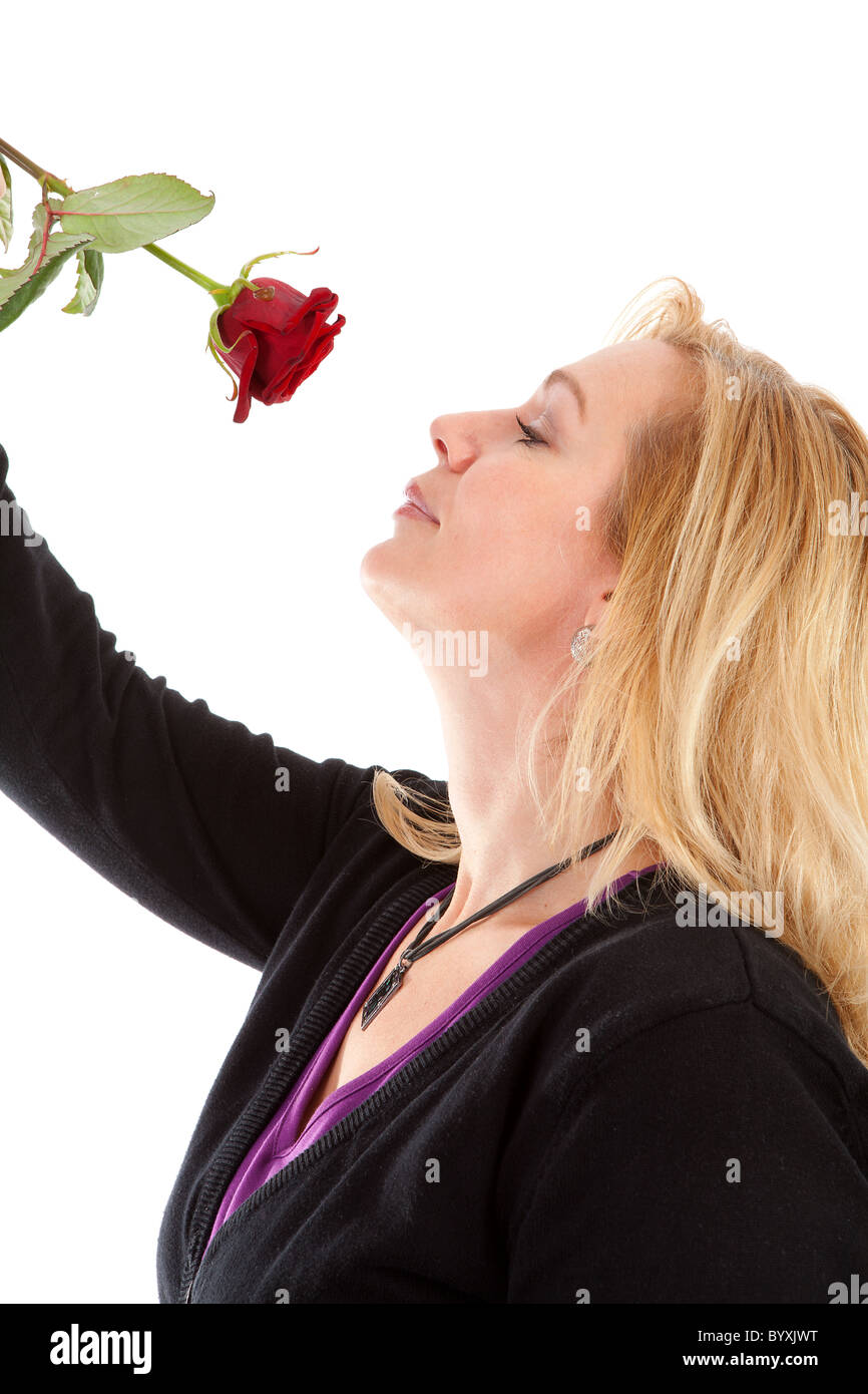woman smelling a red rose in closeup over white background Stock Photo ...