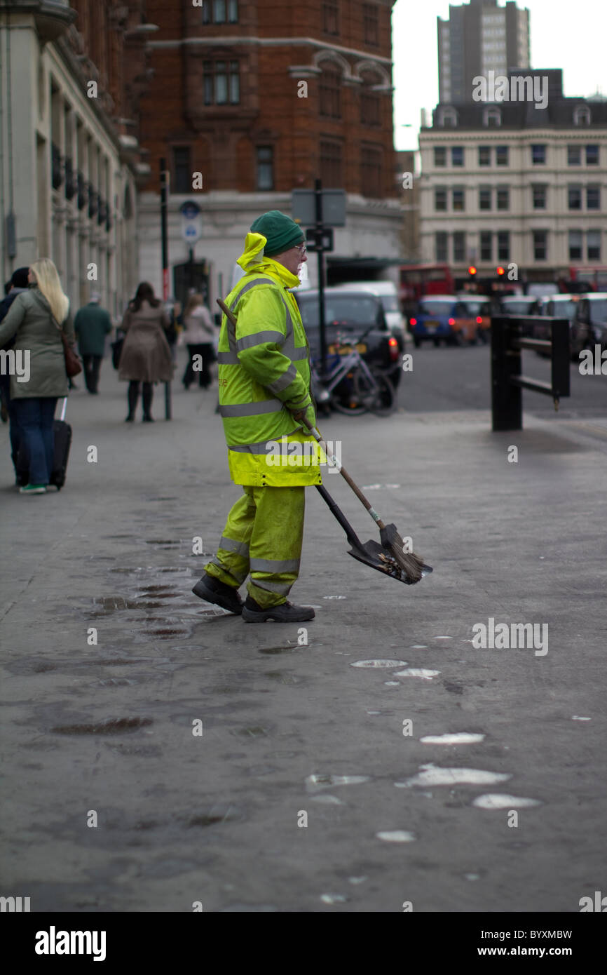 london street cleaner sweep, cleaning streets with brush and spade