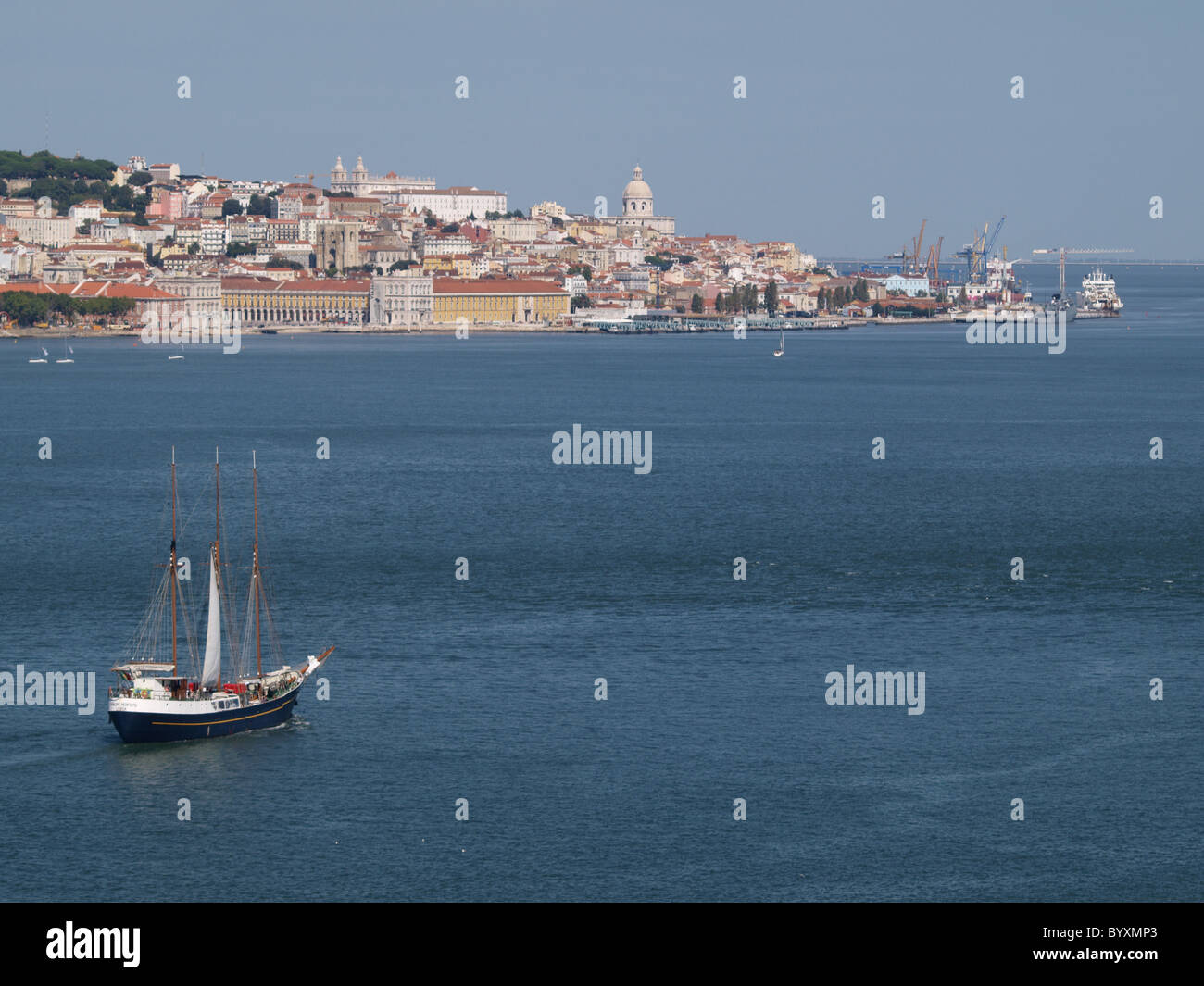 Sailboat in river Tagus in Lisbon with downtown in background Stock Photo