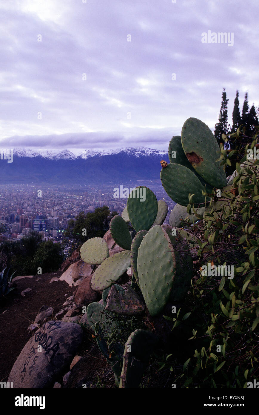 Panoramic view of city from atop Cerro San Cristobal (Parque Metropolitano) during sunrise with distant Andes mountains- Santiag Stock Photo
