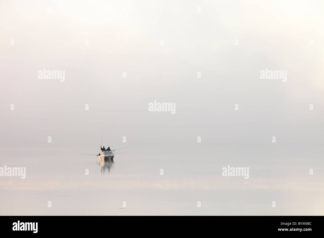 Char fishermen on Lake Windermere on a misty winters morning, Lake District, UK. Stock Photo