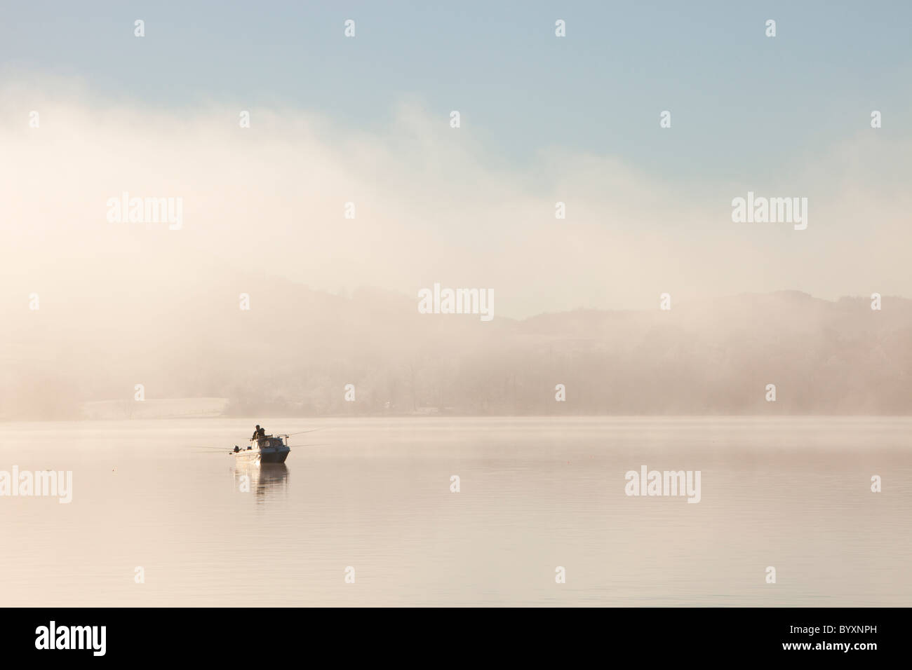 Char fishermen on Lake Windermere on a misty winters morning, Lake District, UK. Stock Photo