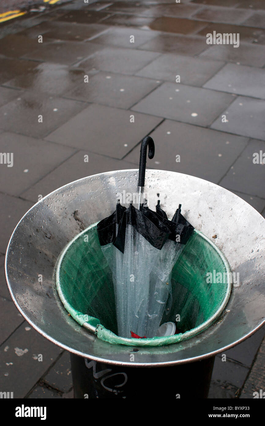 Umbrella thrown away in a rubbish bin on a wet rainy day in Norwich