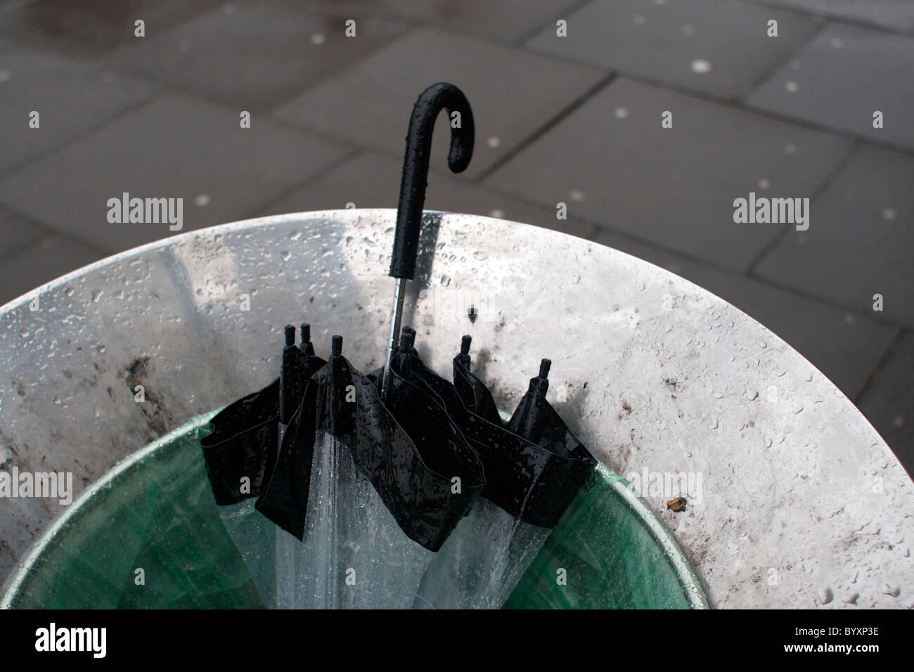 Umbrella thrown away in a rubbish bin on a wet rainy day in Norwich
