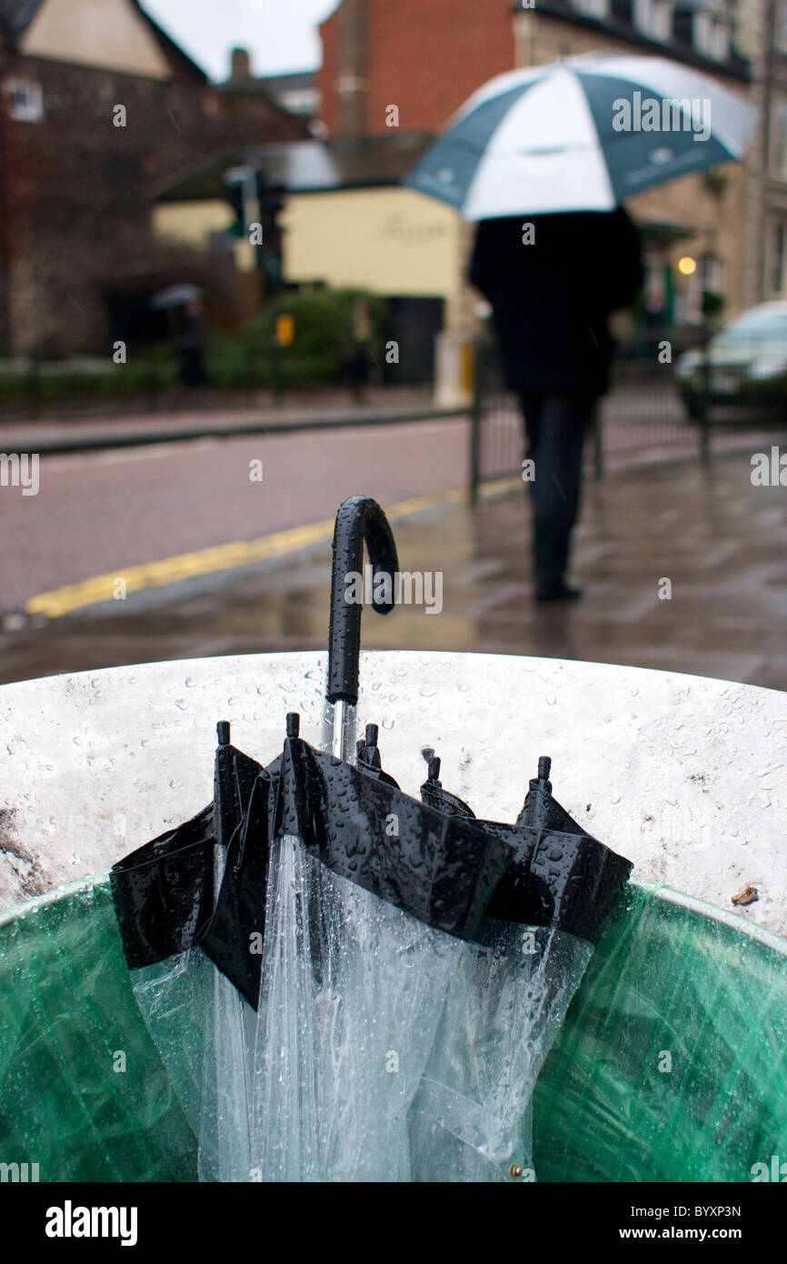Umbrella thrown away in a rubbish bin on a wet rainy day in Norwich