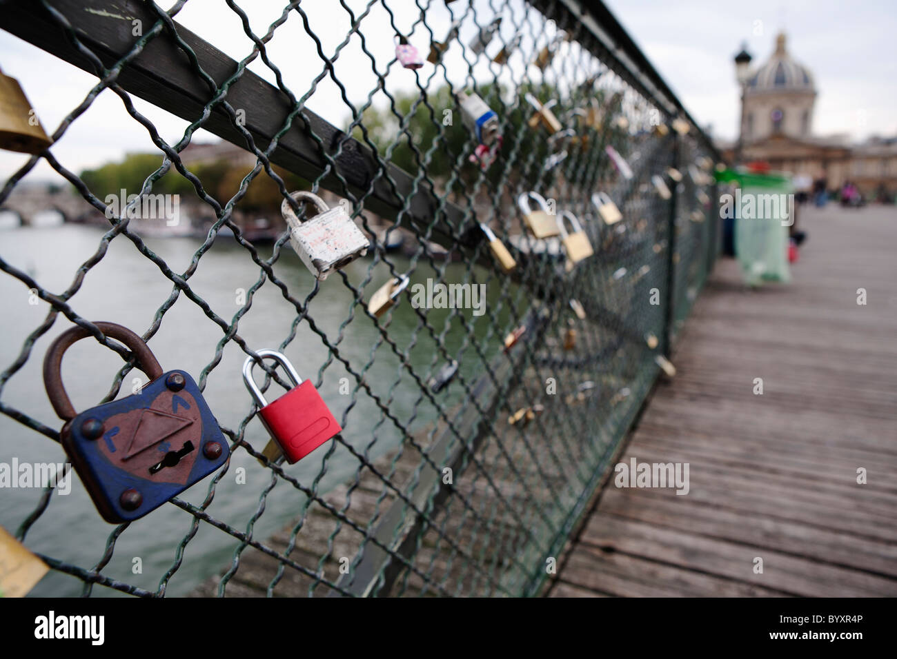 love locks attached to ponts des arts bridge fencing; paris, france