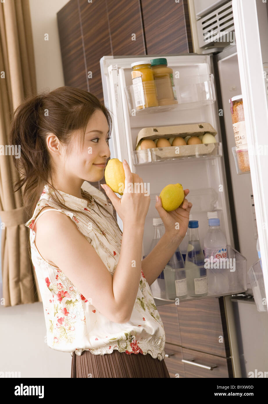 Woman selecting foods from fridge Stock Photo