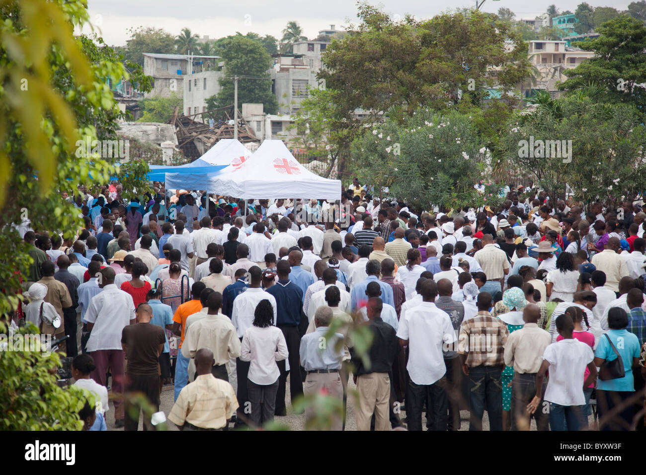 catholic mass being held outside with the great cathedral destroyed by the earthquake; port-au-prince, haiti Stock Photo