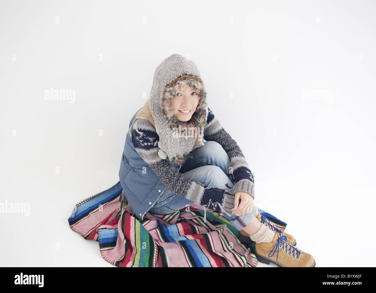 Young woman sitting and hugging her knees Stock Photo - Alamy